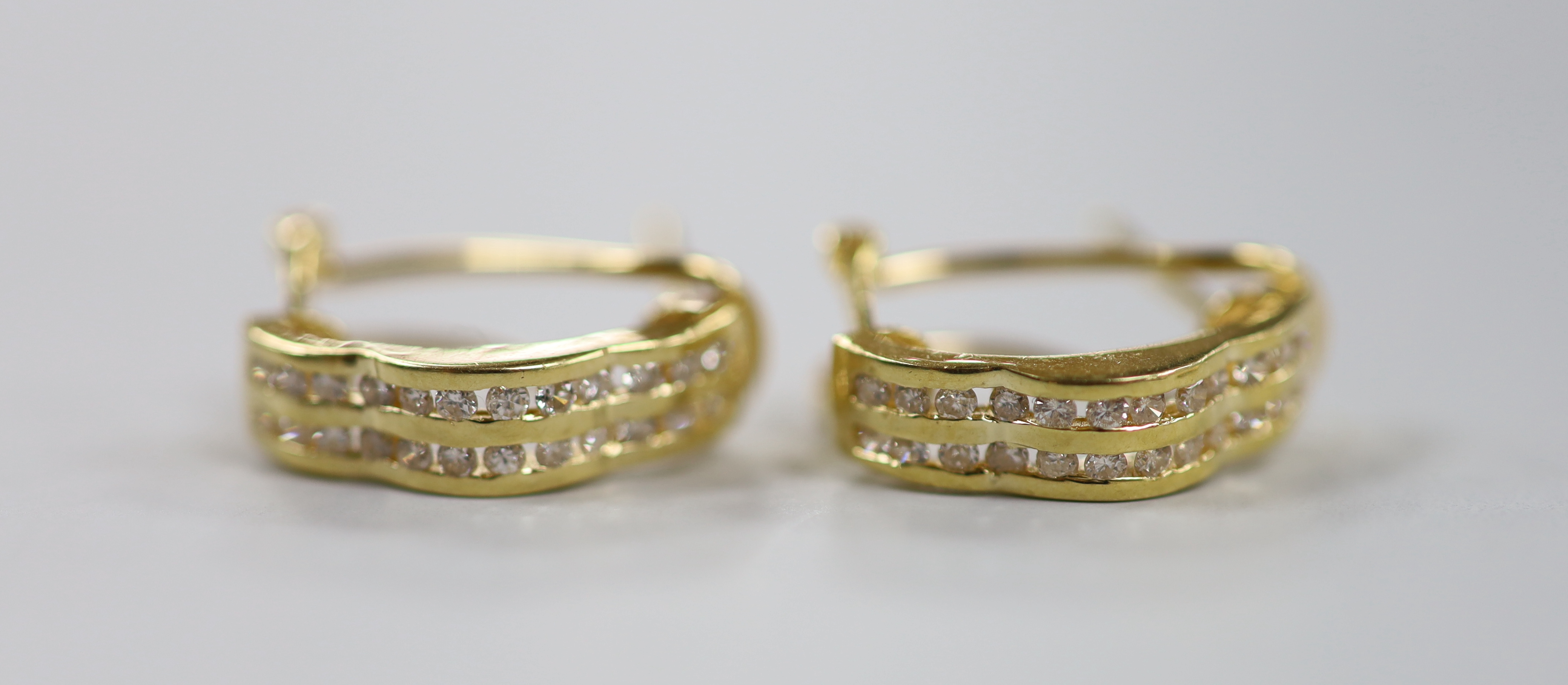 Two modern pairs of 18ct gold and diamond chip cluster earrings, including half hoop, 15mm, gross weight 6.9 grams.